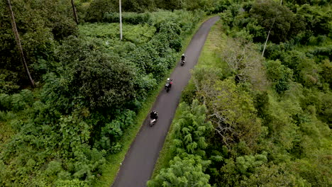 Scooters-cruising-up-rural-road-in-mountains-of-Bali