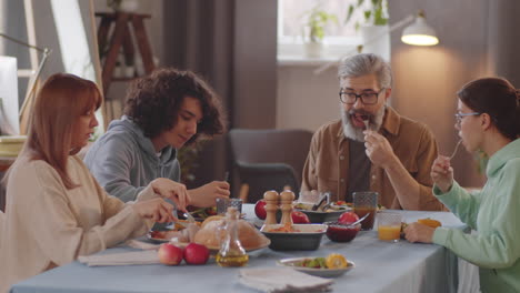caucasian family talking over dinner at home
