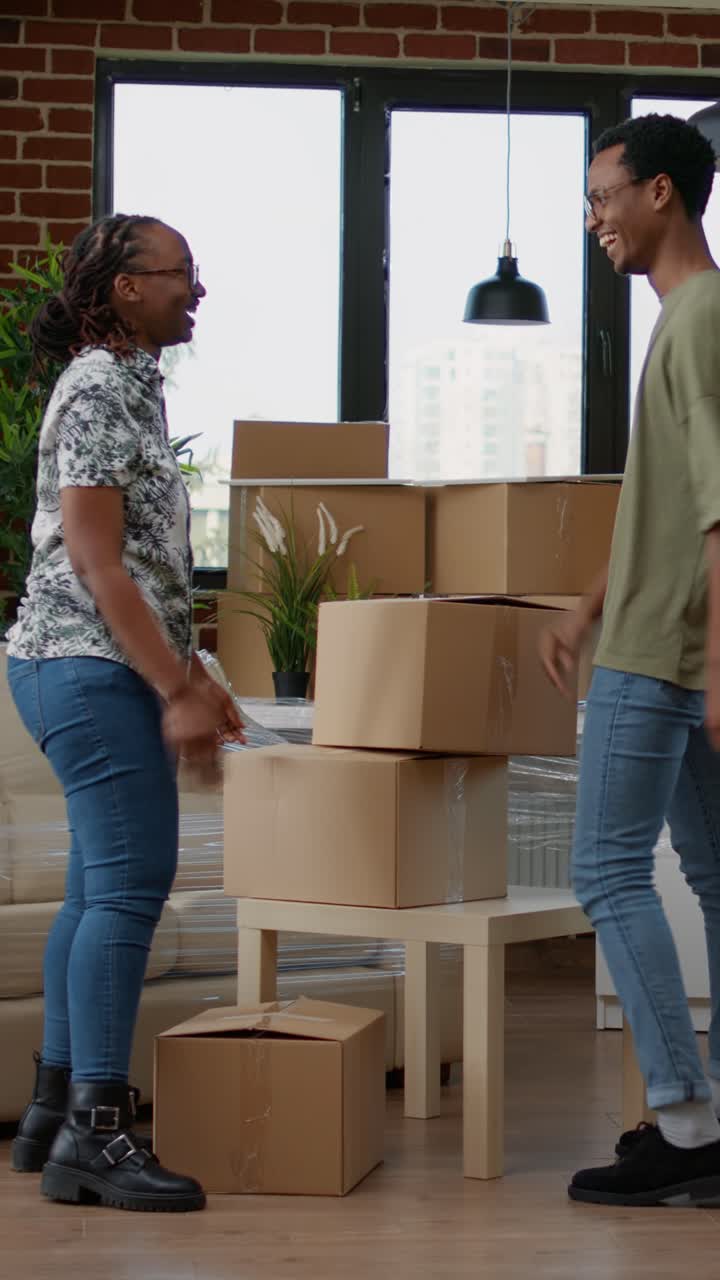 Couple Moving Boxes into New Home