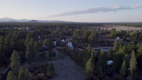 ascending drone shot pushes in, focusing on the three sisters mountains in bend, oregon