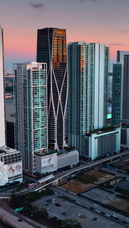 gorgeous skyscrapers in miami downtown. amazing pink and blue sky at the backdrop. vertical video