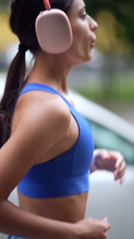 woman running outdoors with headphones