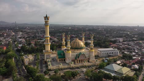 exterior of islamic center ntb with mataram city at daytime in lombok, indonesia