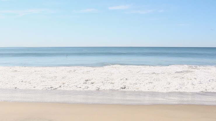 waves crash at the beach in the daytime