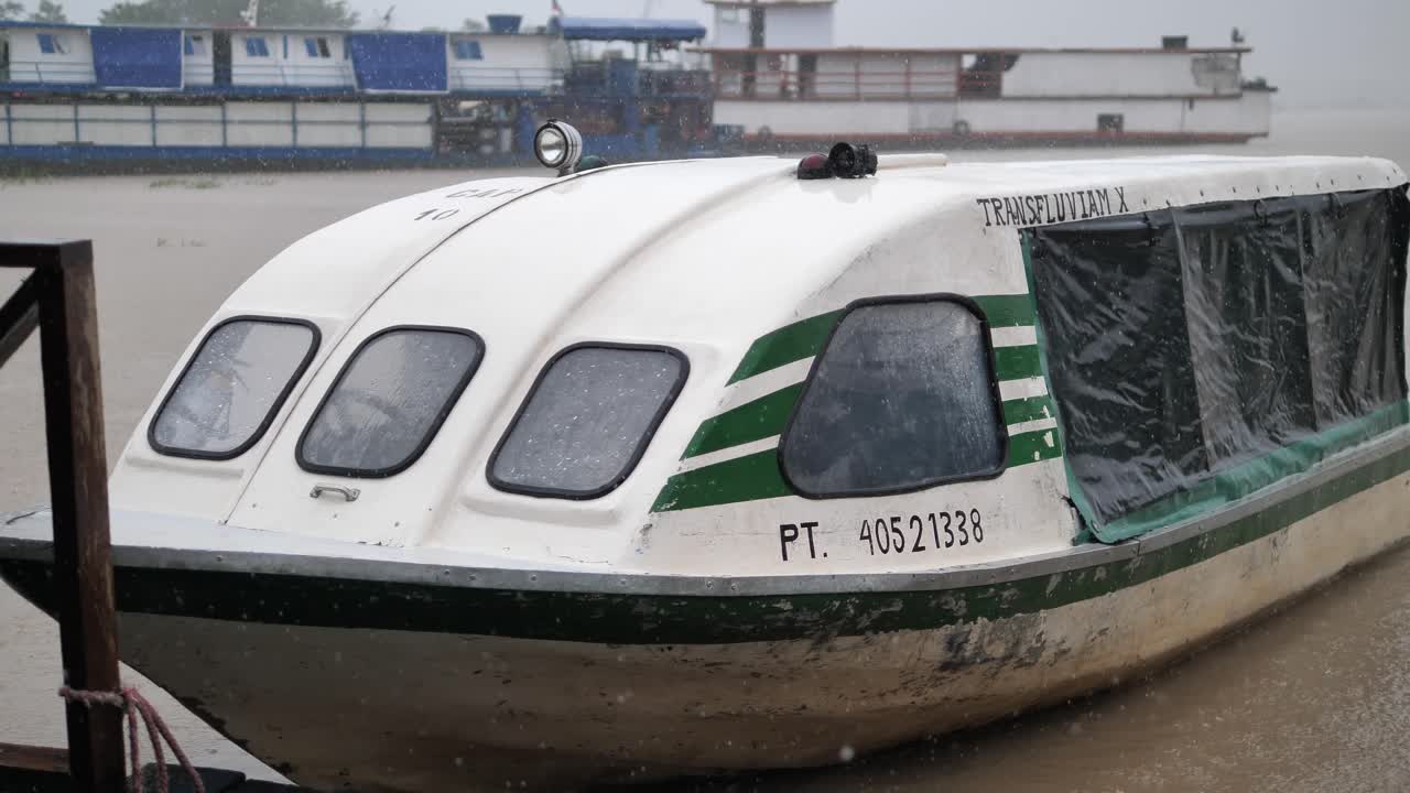 The boat was docked in heavy rain in the Amazon river