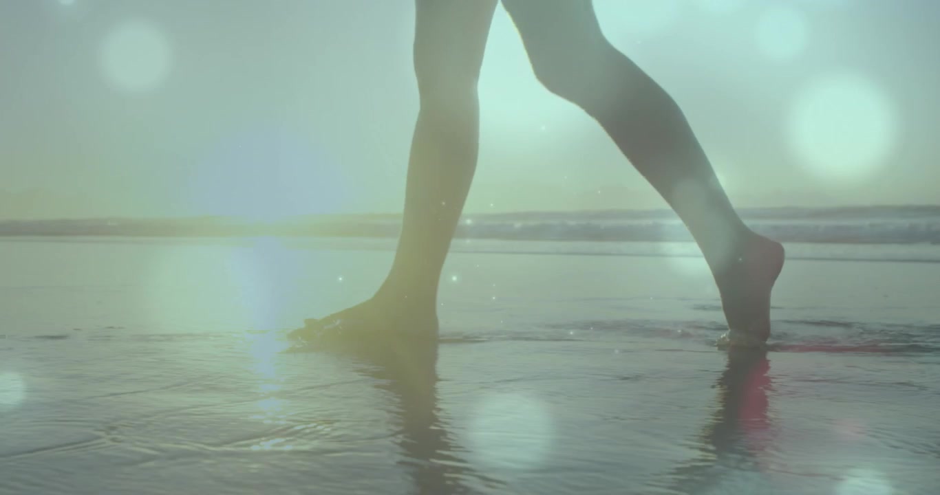 Animation of flag of germany over woman at beach