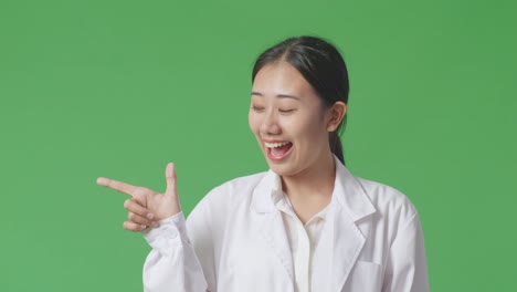 woman in lab coat pointing