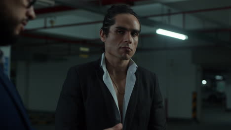 men counting money in a parking garage
