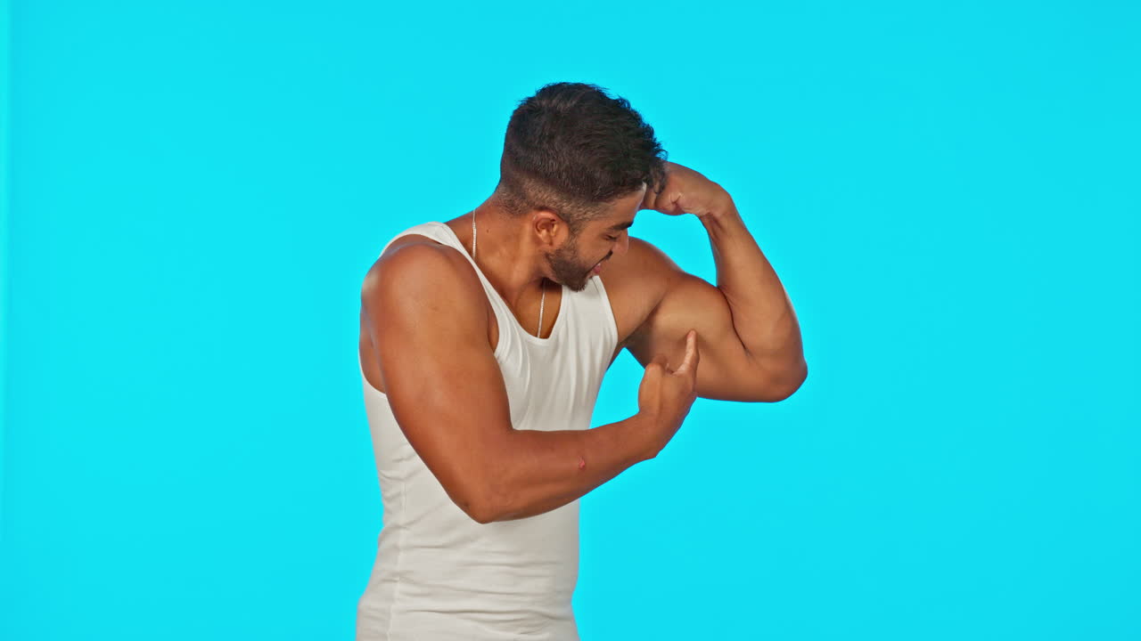 Fitness, bicep and man flexing on blue background