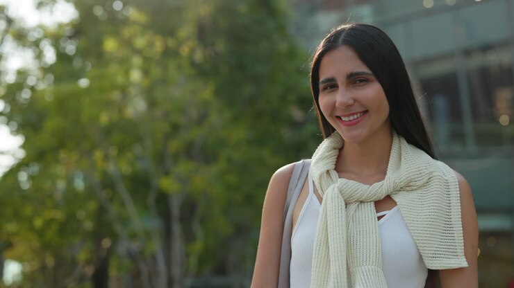 A woman smiling outdoors