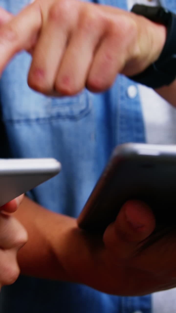 Group of business executives interacting over digital tablet and mobile phone