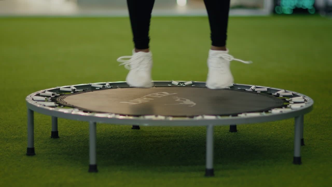 Woman Jumping on a Mini Trampoline