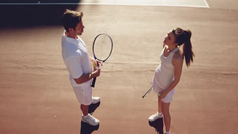 Woman-and-man-playing-tennis-on-a-sunny-day