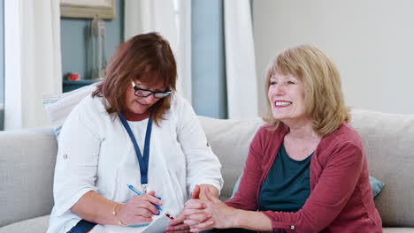 Female-Support-Worker-Visits-Senior-Woman-At-Home