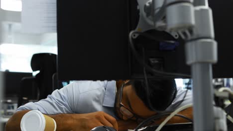 male executive sleeping at desk