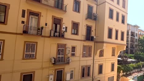 yellow building with balconies and windows