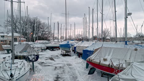 aerial view of winter covered sailboats, winter evening in michigan, usa