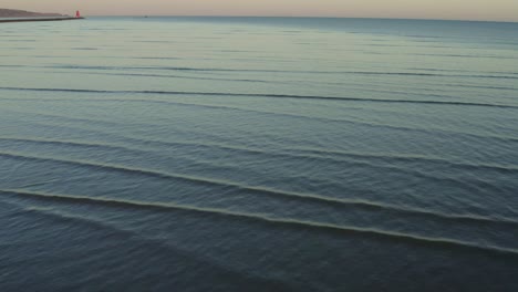 abstract aerial over beautiful low tide ocean waves at sunset background