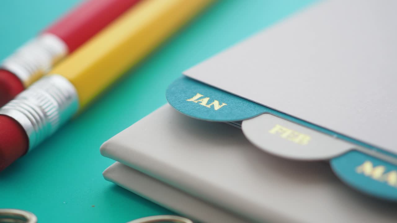 Close-up of a planner with January, February, and March tabs