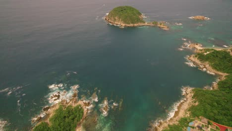 High-altitude-aerial-over-coastline-of-Huatulco,-Mexico