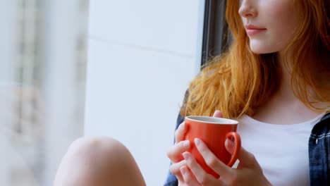 Woman-having-coffee-at-home-4k