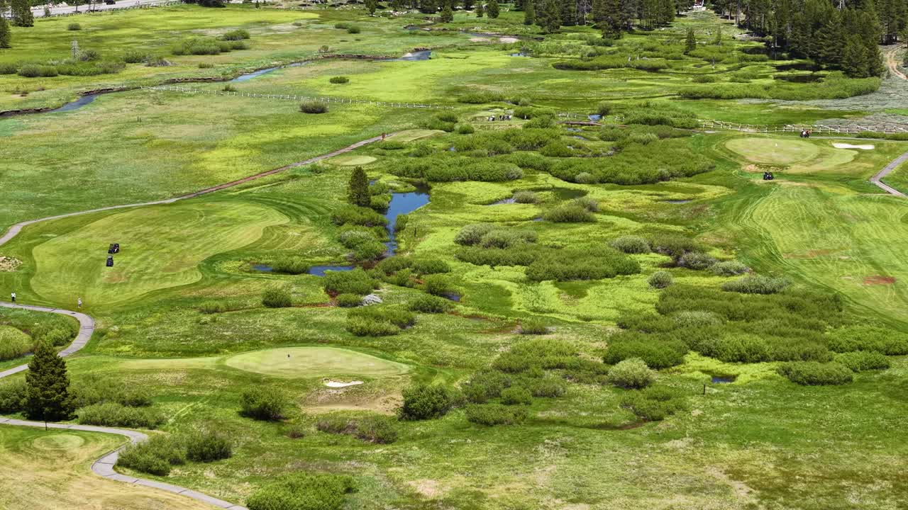Olympic Valley, California USA in Summer Season, Green Fields and Creek Under Hills, Drone Shot