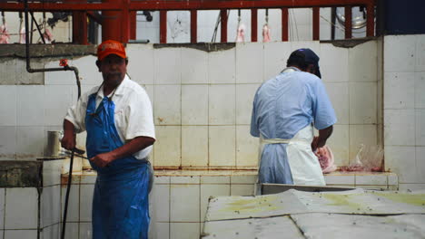 butchers work the meat in a poorly hygienic slaughterhouse. mexico