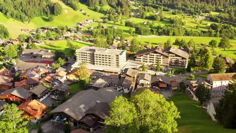 aerial view over buildings and wooden chalet houses of swiss grindelwald village center