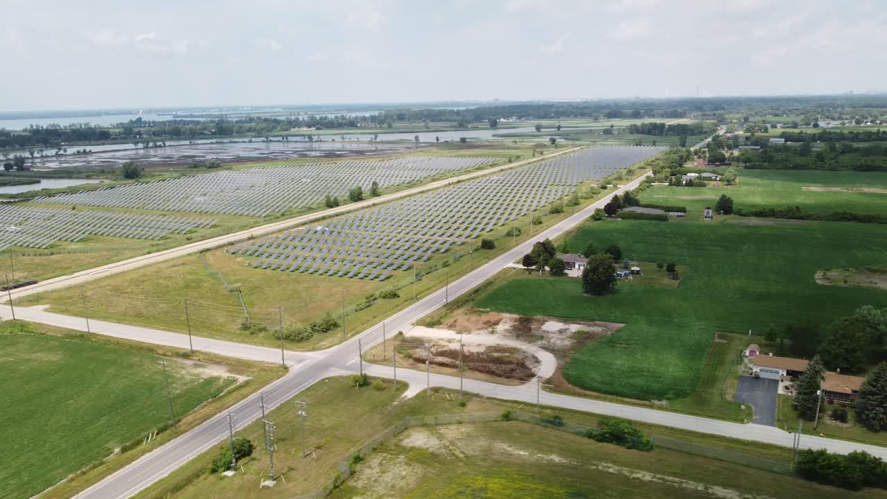 4K Drone Pan of Remote Ontario Solar Farm Amid Natural Landscape