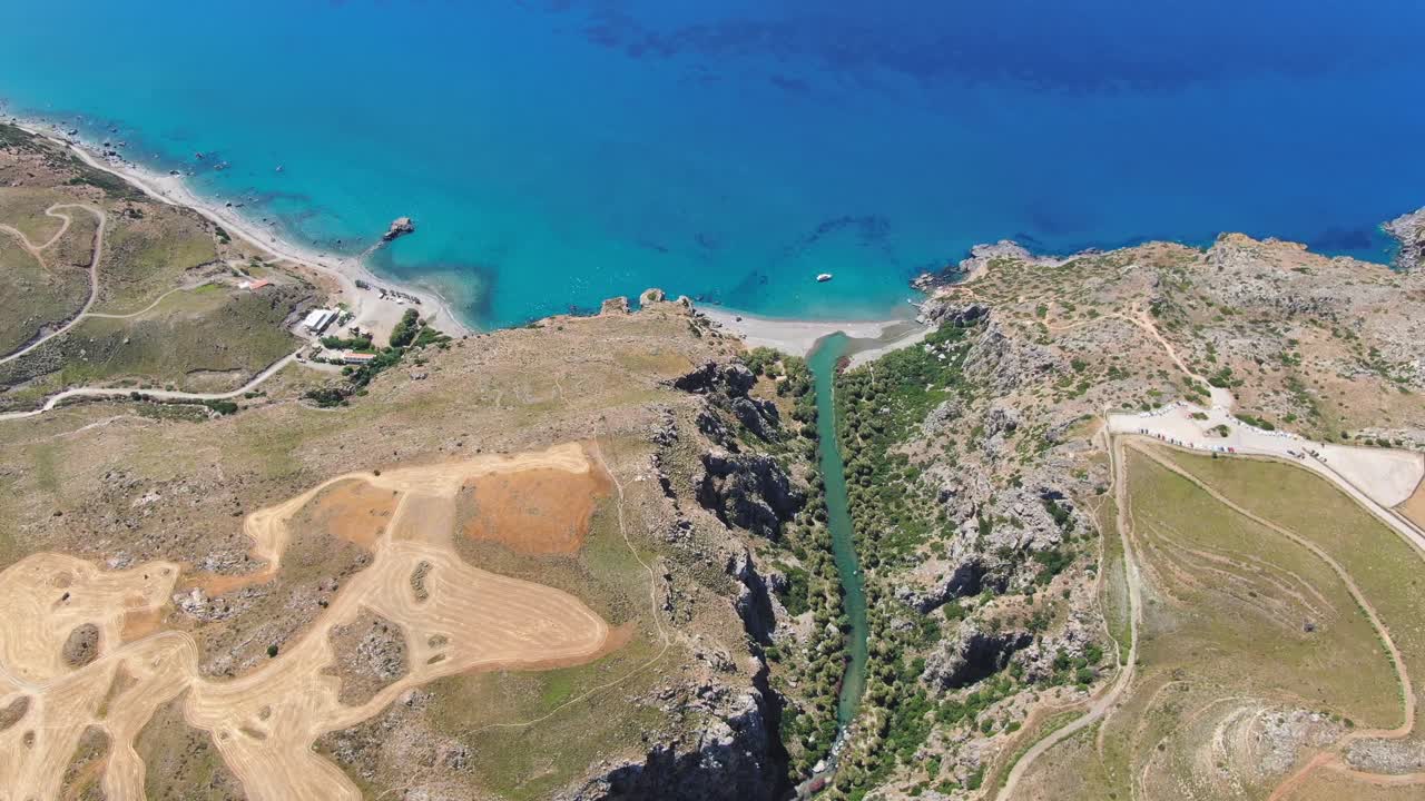 Aerial drone panoramic view of Preveli paradise palm beach and lagoon with the cliff