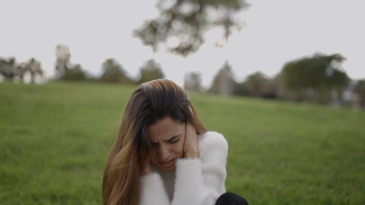 Woman Experiencing Pain or Stress Outdoors