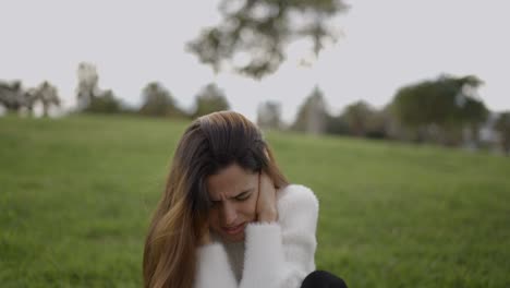 woman experiencing pain or stress outdoors