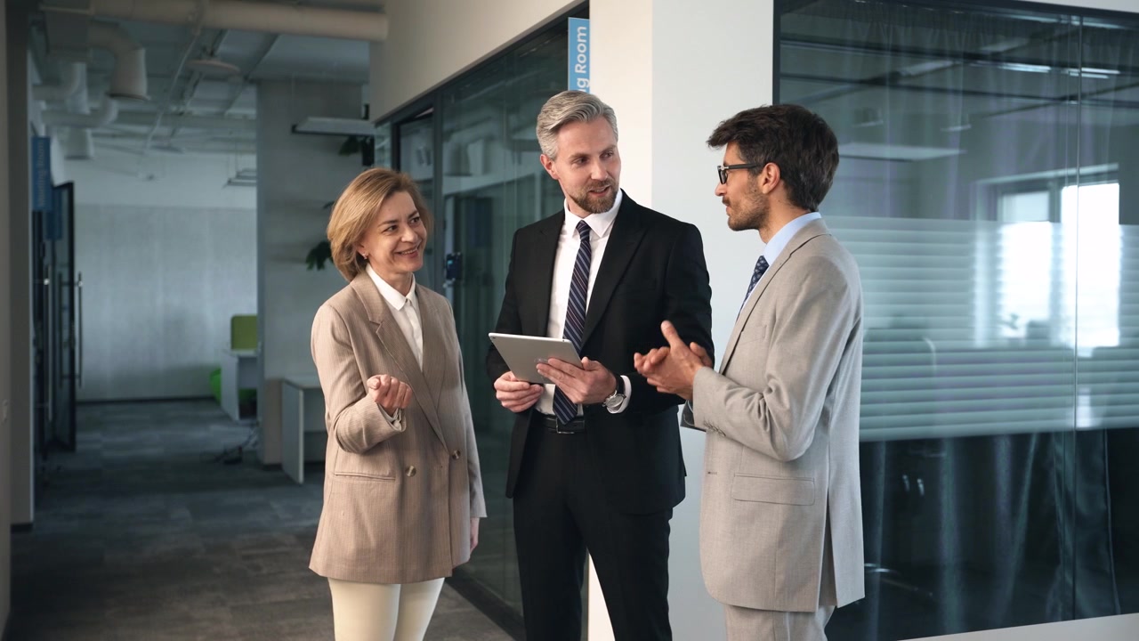 Business Professionals Discussing Project on Digital Tablet in Modern Office