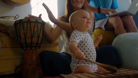 family playing with their baby boy at home 4k