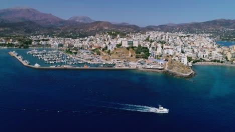 Drone-shot-over-the-marina,-seaside-boulevard,-beaches,-summer-in-Agios-Nikolaos-Crete-Greece