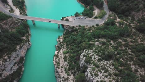 Dolly-high-angle-drone-shot-of-a-bridge-connecting-the-end-of-a-gorge-in-France