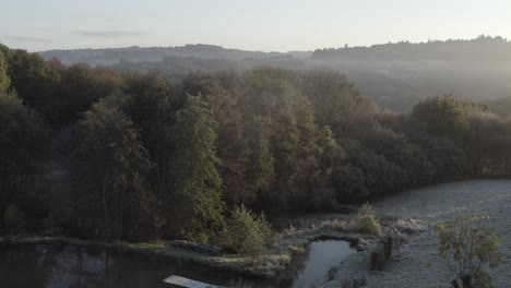 Small-lake-in-rural-countryside-on-foggy-morning,-Correze-in-Nouvelle-Aquitaine,-France