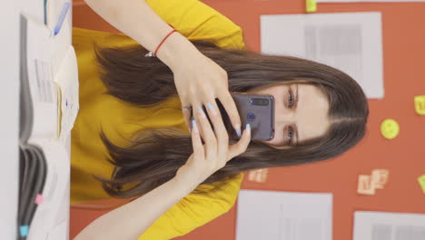 Vertical-video-of-Girl-child-plays-games-on-the-phone-at-home.