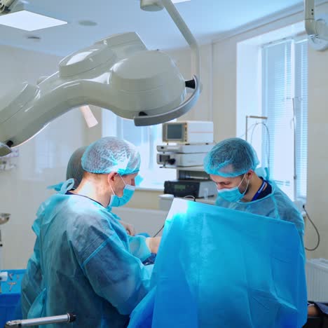 operating theater with surgical process. group of surgical specialists performing an operation in the modern operating room. surgical treatment.