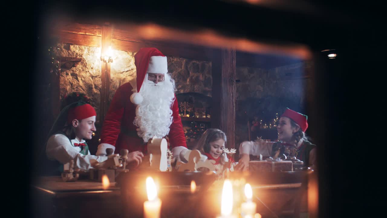 children and elves play with santa claus toys at the christmas residence