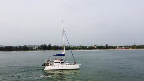 orbit shot of people chilling on luxury boat in stunning surrounding, weligama sri lanka