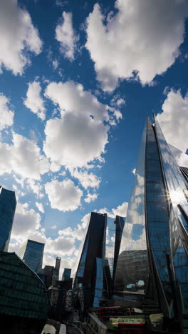 modern glass skyscrapers reflected under a blue sky