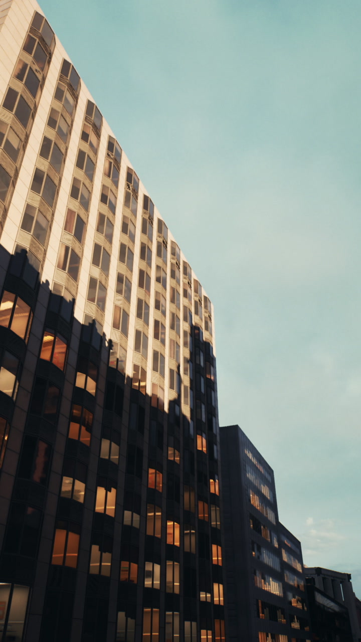Chilly evening city horizon illuminated by cozy interior lighting