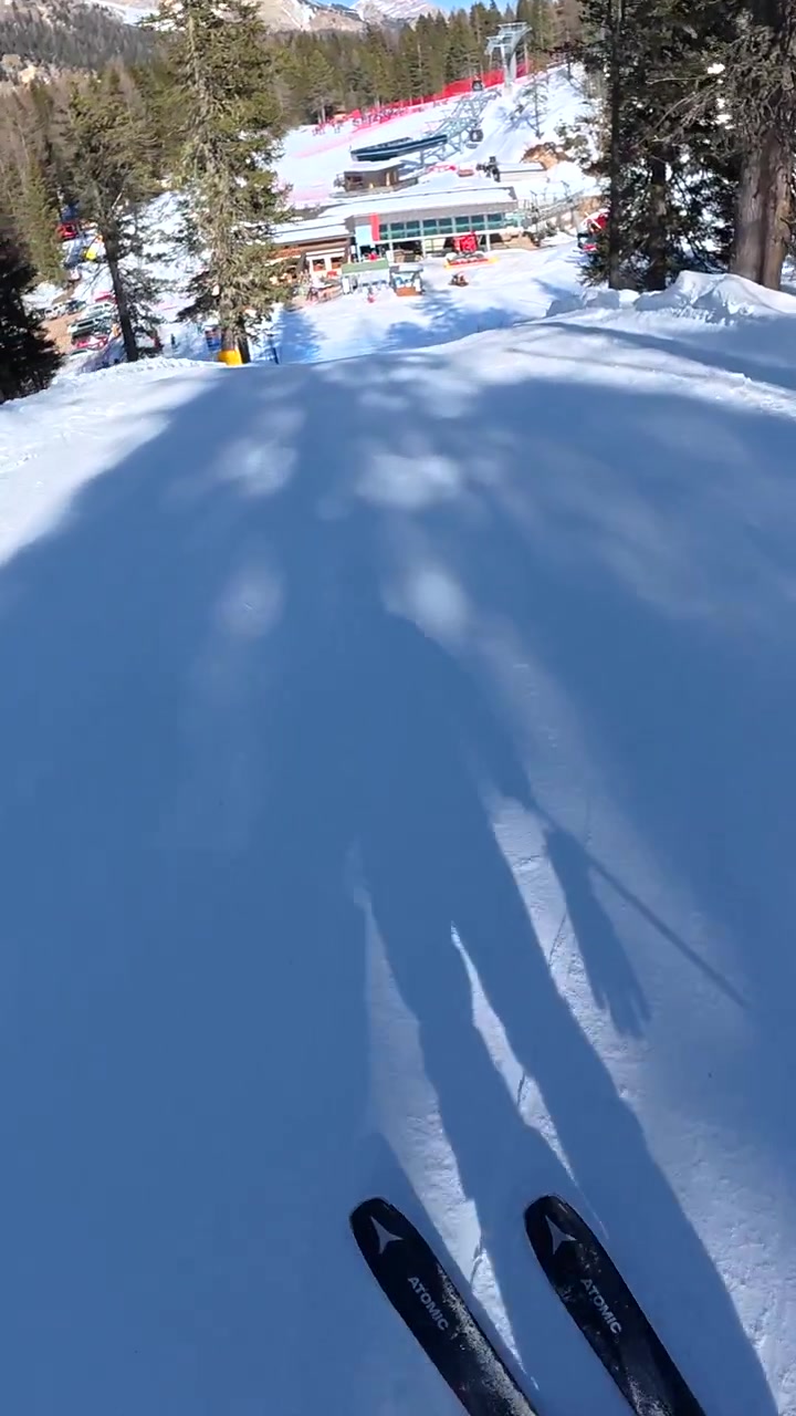 First-Person View of Skier Descending a Snowy Mountain Slope