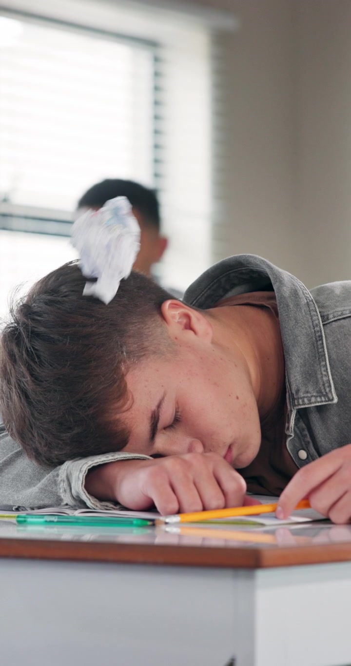 Student Waking Up After Being Hit by Paper Ball in Classroom