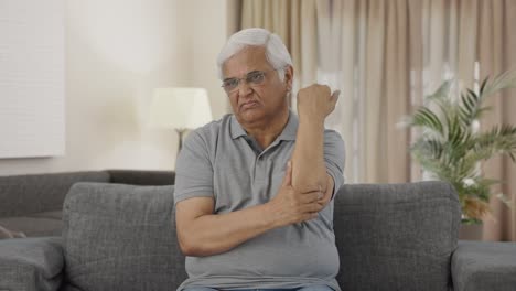 sick indian old man suffering from arthritis