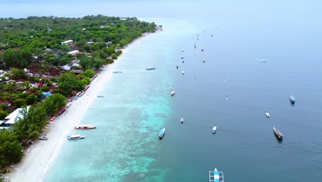 Birds-eye-view-of-boats-floating-on-the-sea-water-surface-along-the-coastline