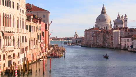 A-gondolier-rows-and-we-reveal-a-beautiful-canal-in-Venice-Italy-2