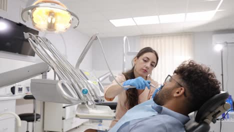 an experienced dentist performs a professional dental checkup focused on patient comfort, hygiene, and modern treatment in a clean clinical environment.