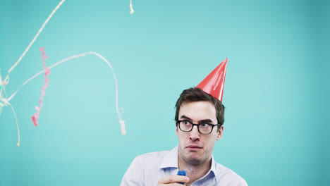 crazy face man pulling party popper slow motion photo booth blue background